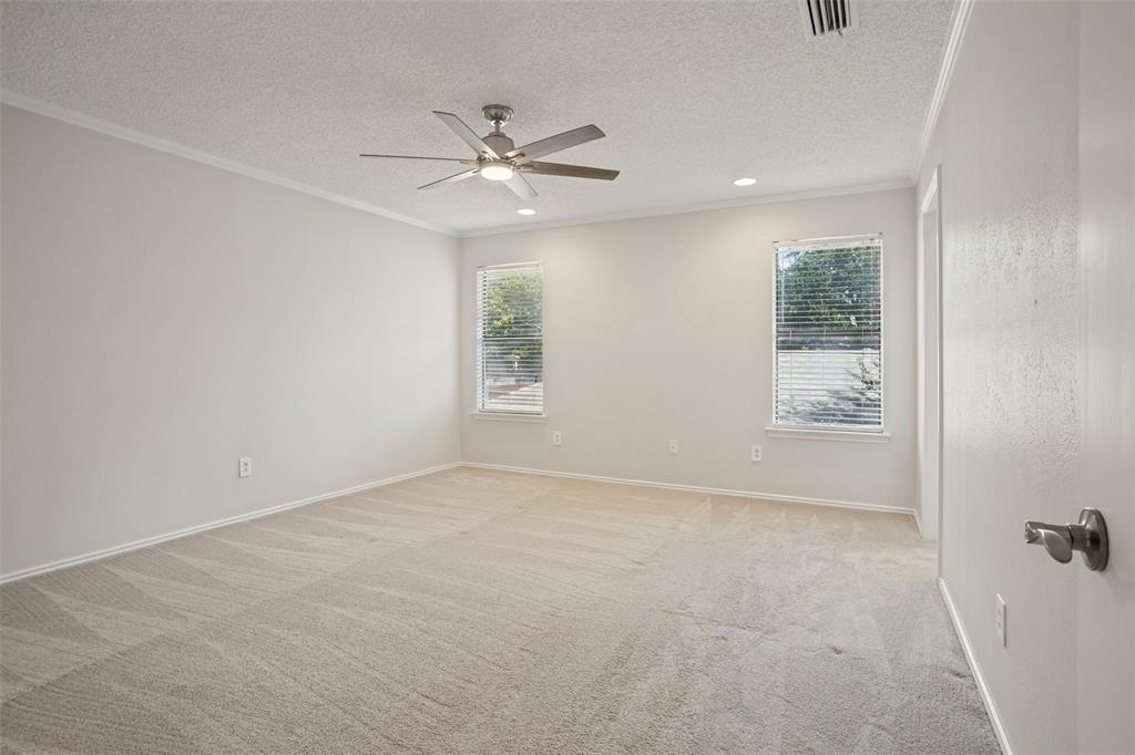 Primary bedroom with ensuite bath and two walk-in closets.