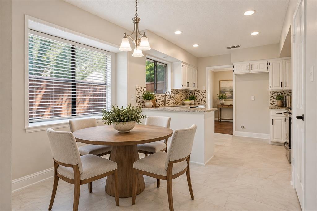 Breakfast area and kitchen, virtually staged.