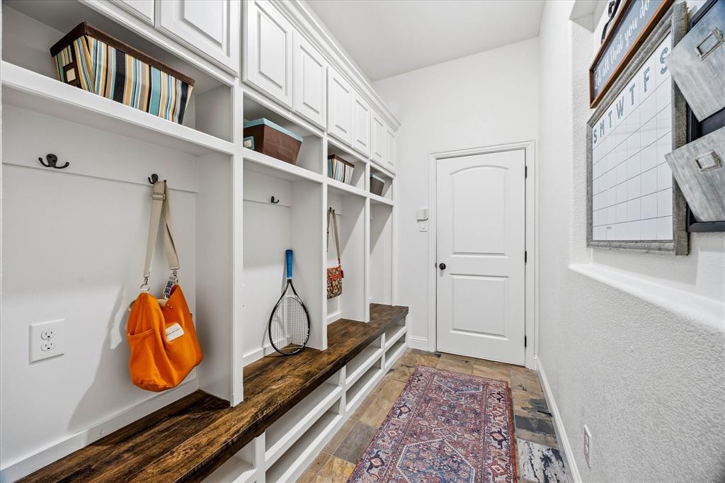 Custom drop off area opens onto garage