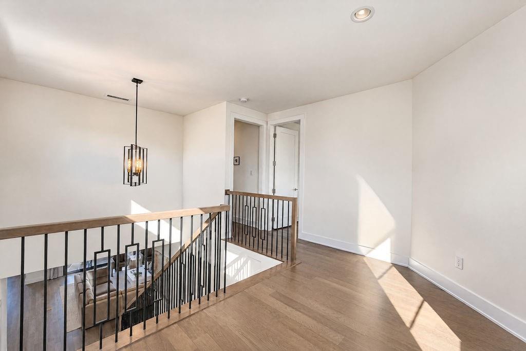 The top of the stairs opens into a wide hallway, keeping the upper level feeling open and easy to navigate
