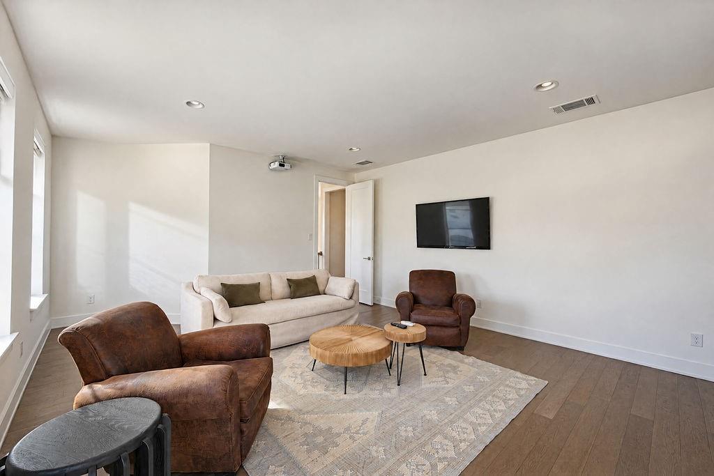 A dedicated game room equipped with a projector creates the ultimate home theater for sports, gaming, or movie marathons