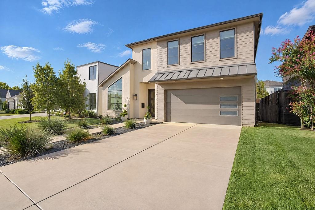A driveway and two-car garage offer easy parking for guests