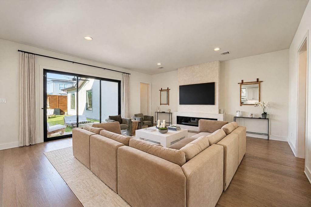 Sliding glass doors open directly to the back patio, letting fresh breeze fill the main living area on warm afternoons