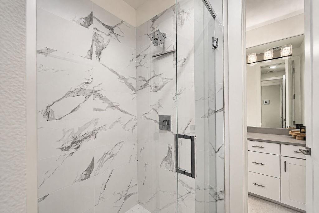 The two rooms share a water room with a walk-in shower