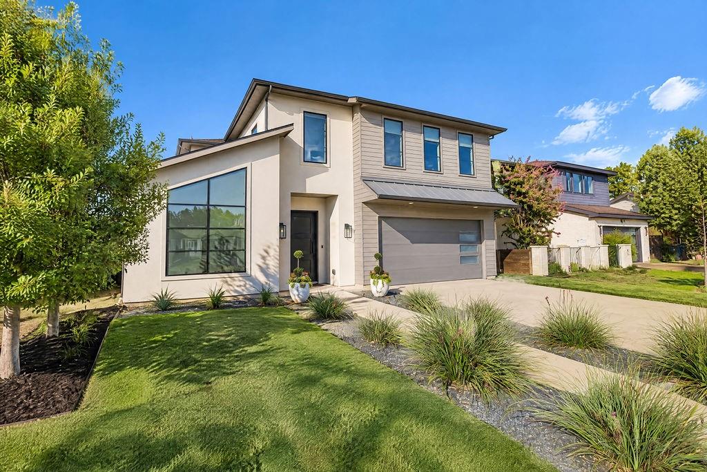 Beautiful landscaping and clean architectural lines create warm curb appeal every time you arrive home