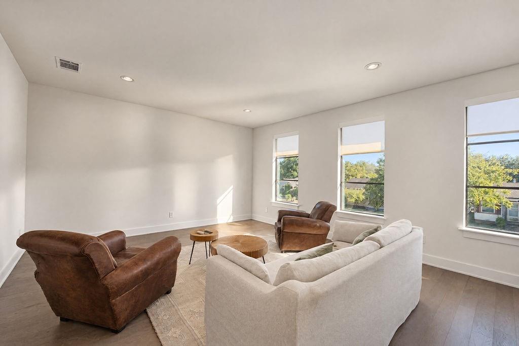Deep layout proportions in the game room easily accommodate lounge seating and gaming tables