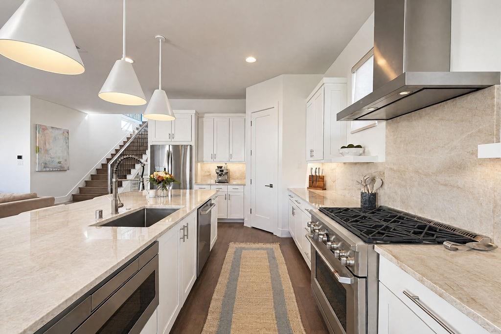 Stainless appliances, gas cooking, and a built-in microwave keep meal preparation streamlined and organized