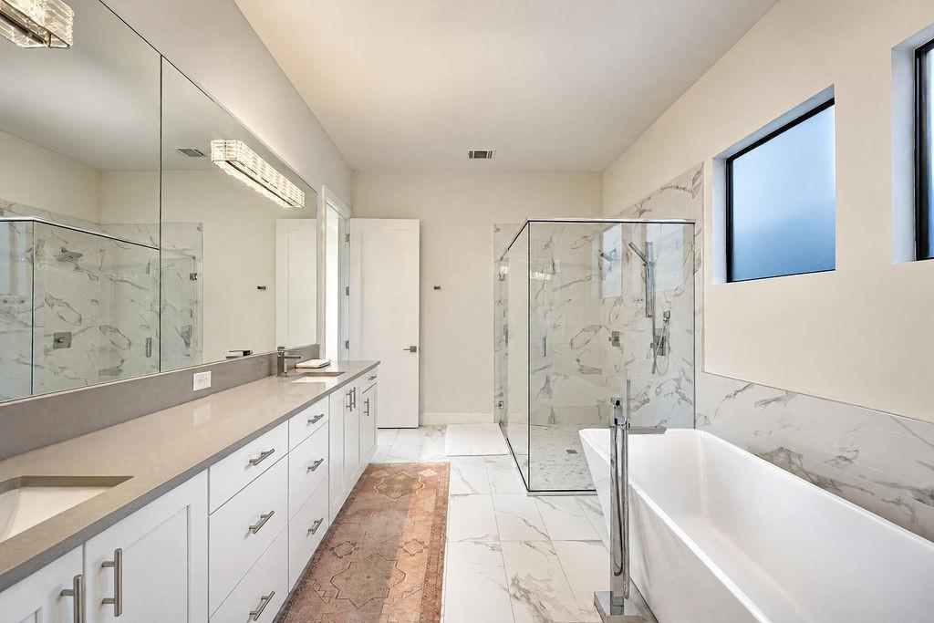A long dual vanity with plenty of counter space and drawer storage keeps morning routines calm and effortless