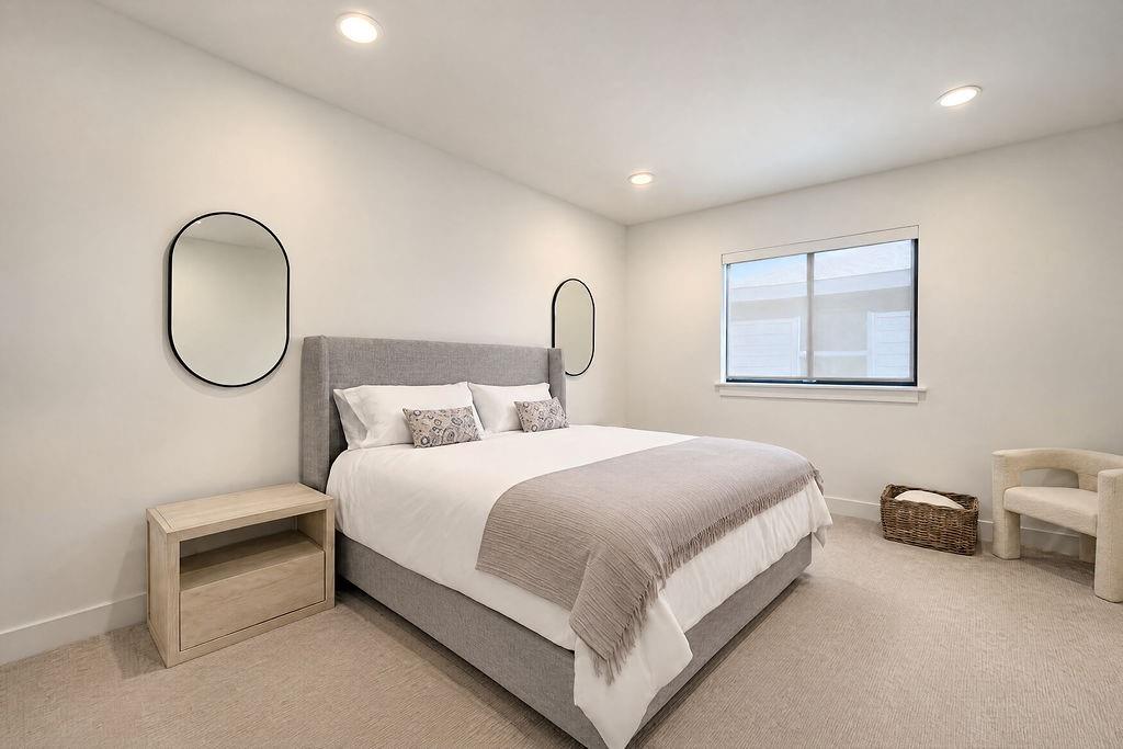 Soft carpeting and dreamy natural light make this upper-level guest room a cozy retreat for overnight stays or quiet afternoon reading