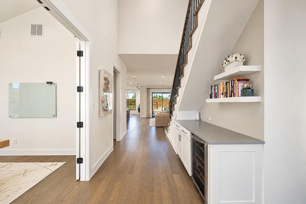 Step into a welcoming hallway where built-in wine storage under the staircase keeps your collection organized right near the front door