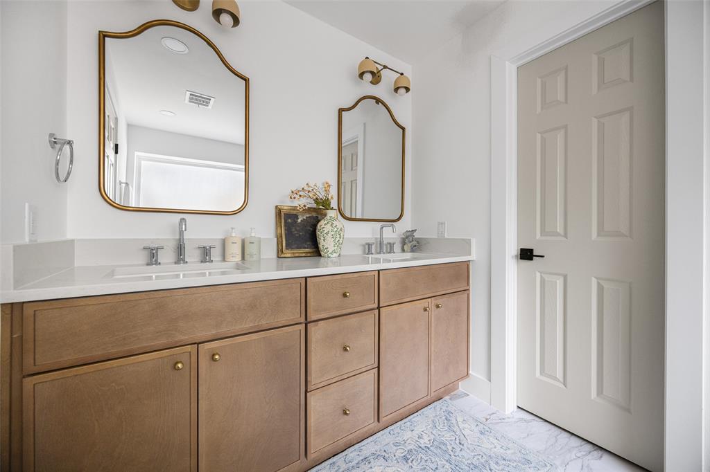 This beautifully renovated, spa-inspired primary bathroom offers a luxurious retreat.