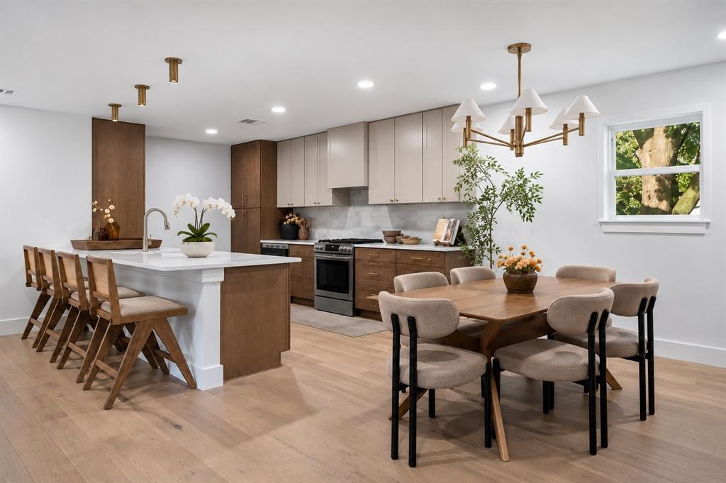 Welcome to this beautifully renovated home, where timeless style meets modern comfort. The spacious kitchen island provides the perfect setting for casual dining and entertaining. (This photo has been digitally enhanced.)