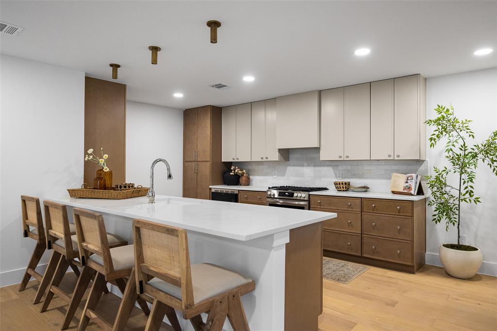 With new stainless steel appliances, fresh cabinetry, and crisp countertops, the kitchen is both delightful and intentional.