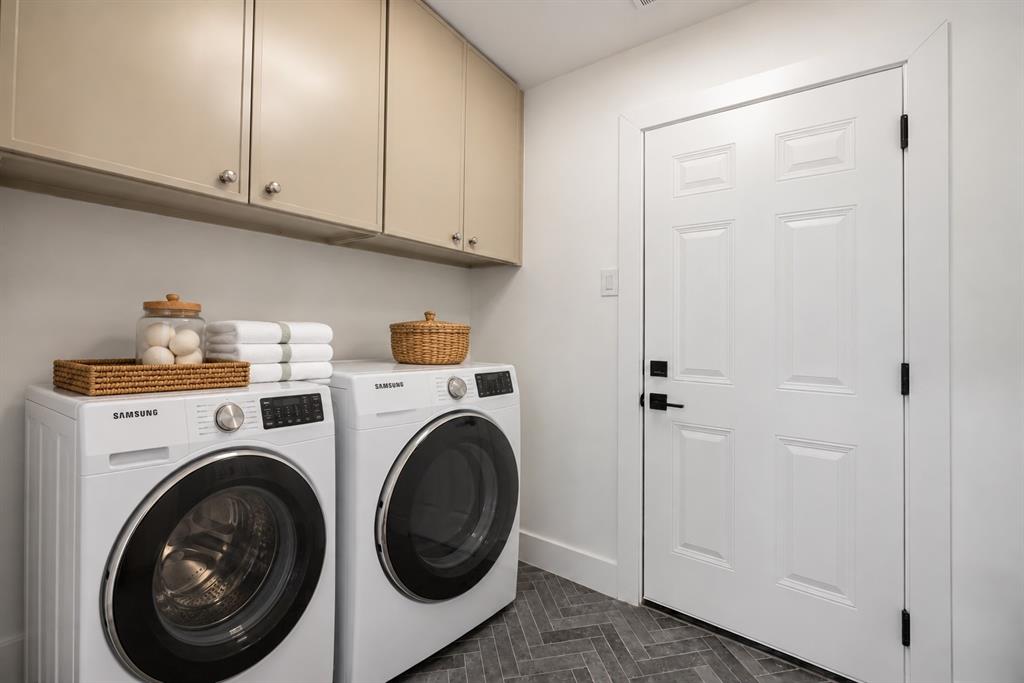 This thoughtfully designed laundry room offers ample cabinet storage and a convenient, functional space for everyday living. (This photo has been digitally enhanced. Washer and dryer do not convey with the sale of this property.)