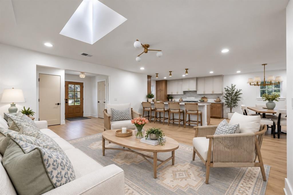 The thoughtfully appointed living room offers a bright, comfortable space for relaxing and entertaining. (This photo has been digitally enhanced.)