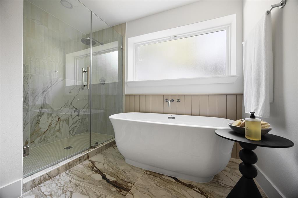 Exquisite tilework, a frameless glass-enclosed shower, and a luxurious garden soaking tub bring the ultimate relaxation experience.