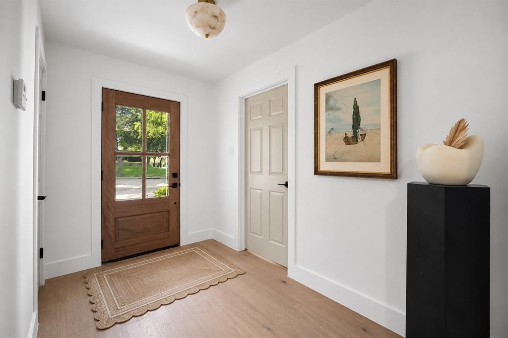 This beautifully appointed entryway offers a warm and welcoming introduction to the home, blending timeless elegance with modern style.