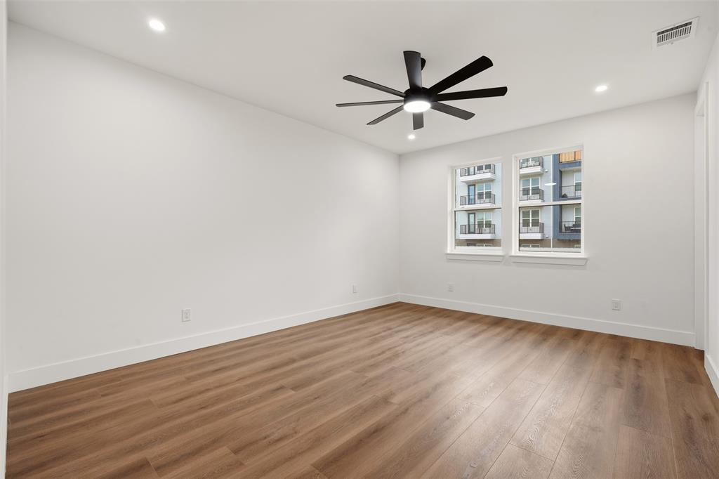 Interior room featuring wood-finish flooring, recessed lighting, and a multi-blade ceiling fan with integrated lighting