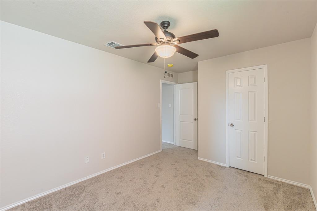 Spacious room featuring neutral carpet flooring and light-toned walls