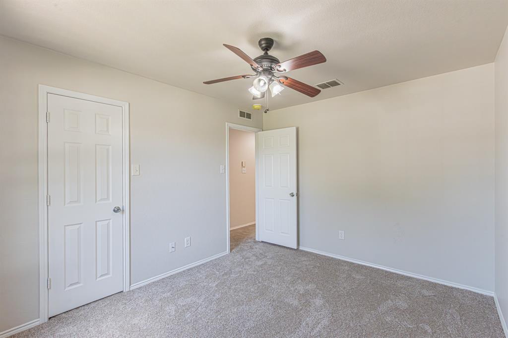 Neutral-toned walls complement the light-colored carpet flooring