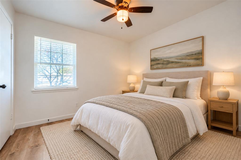 Wood-finish flooring, ceiling fan with integrated lighting, and neutral wall tones