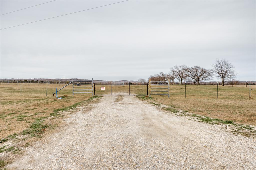 View of street with a gate, a view of countryside, and a gated entry