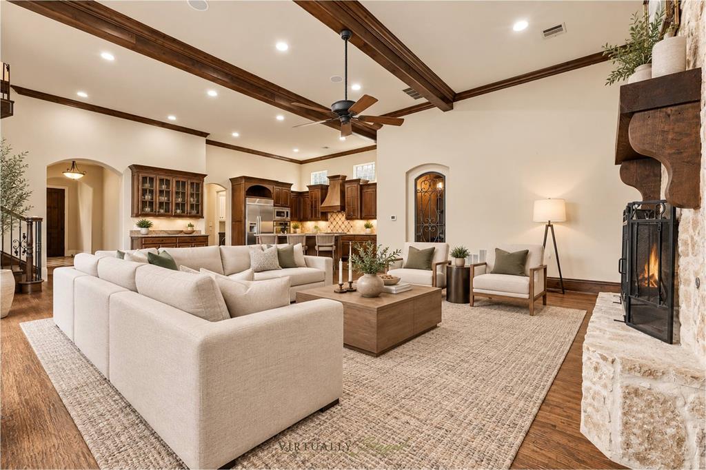 Large Living Area With Fireplace, Built-Ins, Beamed Ceiling, And Access To The Side Patio.