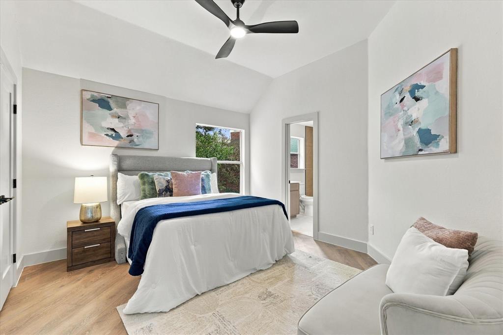 Vaulted ceilings, wood-finish flooring, and a modern ceiling fan