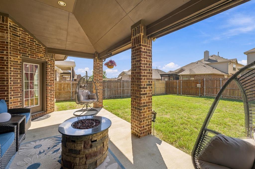 Covered patio with a concrete floor, brick exterior masonry, structural brick support columns, recessed ceiling lighting, and a fenced backyard