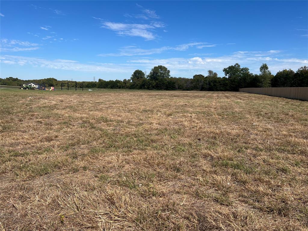 Expansive parcel of land featuring level terrain and perimeter wood fencing Expansive parcel of land featuring level terrain and perimeter wood fencing