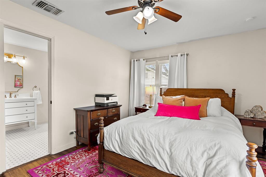 Bedroom featuring wood-finish flooring and a ceiling fan with light fixture