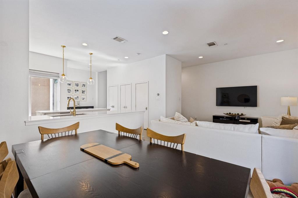 Kitchen featuring a peninsula with solid-surface countertops, recessed ceiling lighting, and pendant fixtures
