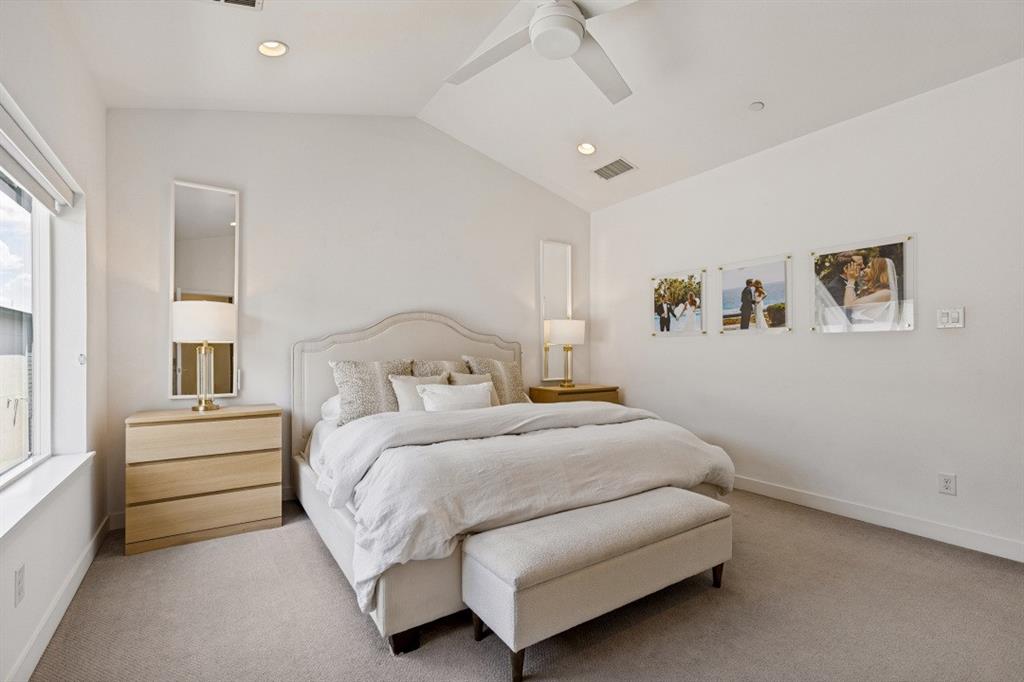 Vaulted ceilings, neutral carpeted flooring, recessed lighting, and a modern ceiling fan