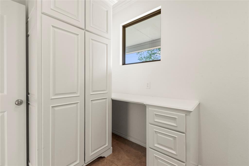 Laundry room featuring floor-to-ceiling cabinetry, built-in drawers, and countertop space for extra storage.
