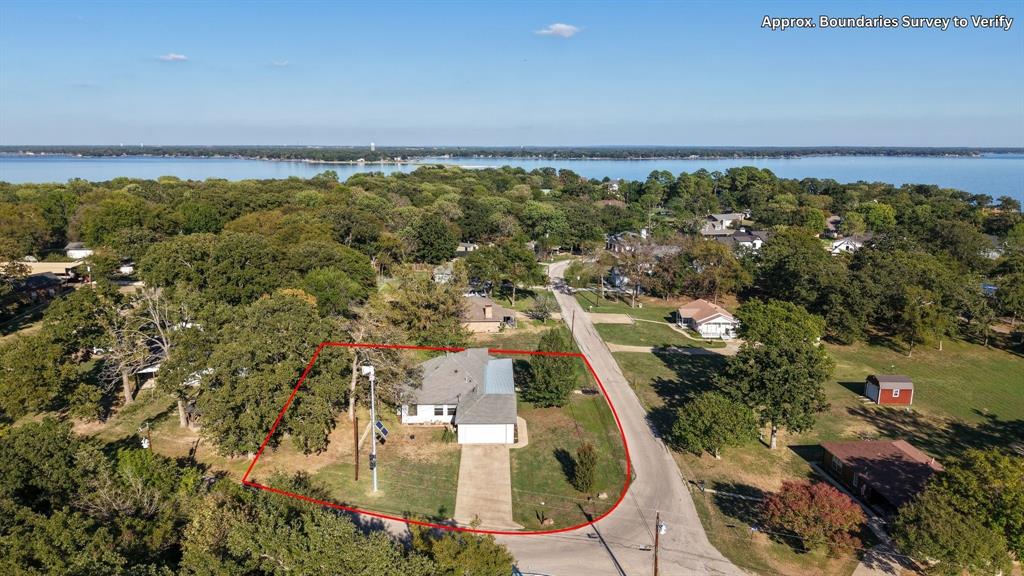 Aerial view highlighting the corner lot, surrounding neighborhood, and proximity to the lake. Aerial view highlighting the corner lot, surrounding neighborhood, and proximity to the lake.