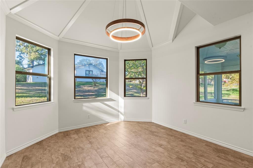 Dining area surrounded by windows providing abundant natural light and views of the outdoors.