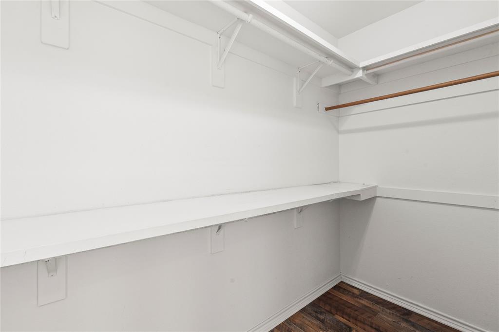 Ensuite bedroom two large Walk-in closet with built-in shelving and hanging rods.