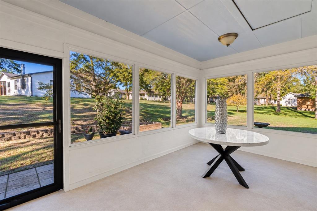 Screened porch with walls of windows overlooking the backyard. Screened porch with walls of windows overlooking the backyard.