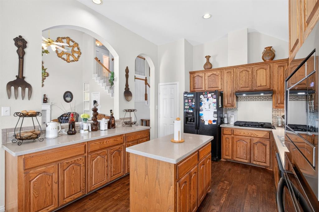 Kitchen with gas cooktop, a center island and abundant cabinet storage.