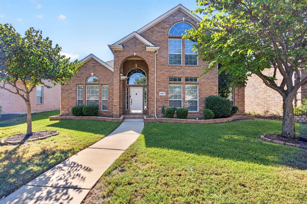 Welcoming brick exterior with an arched entry, mature trees and a landscaped front lawn. Welcoming brick exterior with an arched entry, mature trees and a landscaped front lawn.