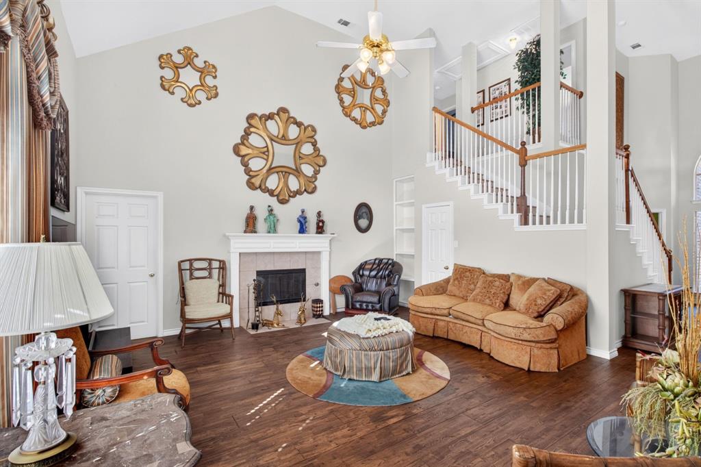 Gas fireplace anchors the living area, with a view toward the open staircase.