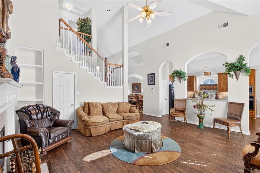 Soaring ceilings, an open staircase and wood-look flooring connect the main living spaces. Soaring ceilings, an open staircase and wood-look flooring connect the main living spaces.