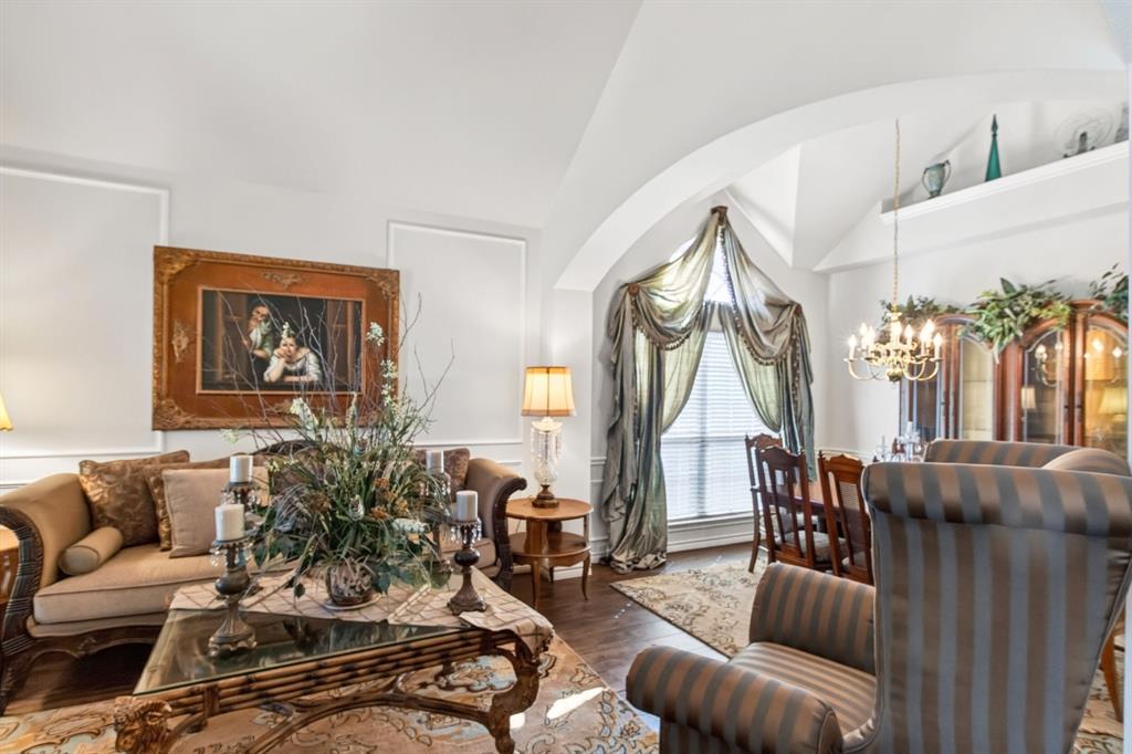 Formal living room with tall ceilings and an open connection to the dining area. Formal living room with tall ceilings and an open connection to the dining area.
