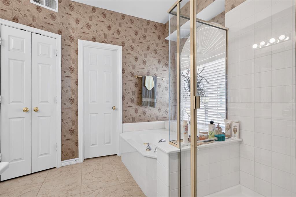 Primary bathroom with a separate shower and soaking tub.