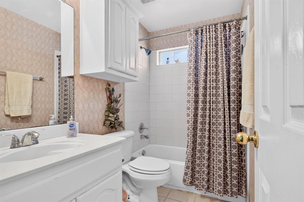 Full bathroom with a vanity and tub-shower combination.