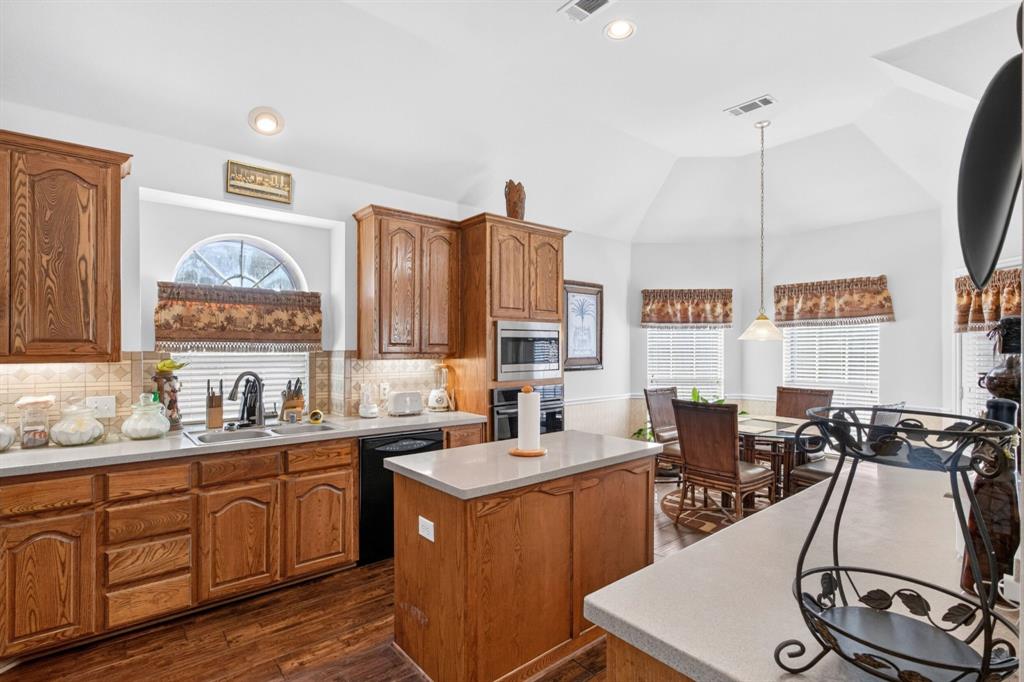 Island kitchen with gas cooking, abundant wood cabinetry, built-in ovens and an adjoining breakfast area. Island kitchen with gas cooking, abundant wood cabinetry, built-in ovens and an adjoining breakfast area.