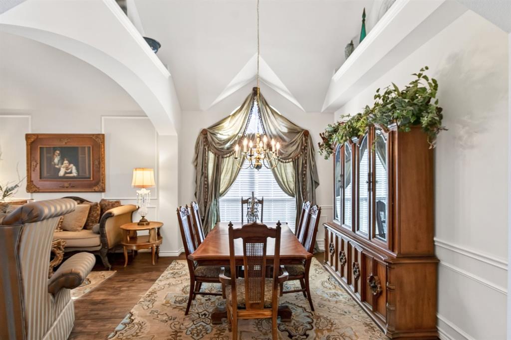 Dining area with a chandelier and a large window overlooking the front of the home. Dining area with a chandelier and a large window overlooking the front of the home.