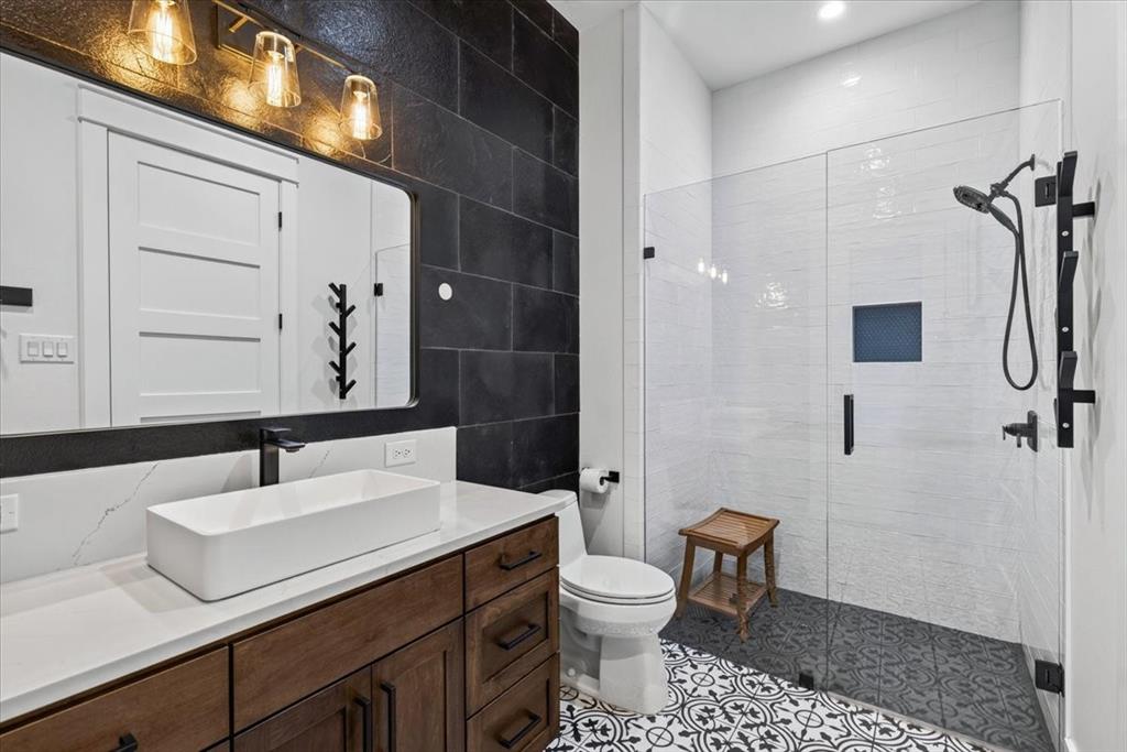 En suite Bath Two features a walk-in shower and exterior access to the patio for added convenience. Main Residence.