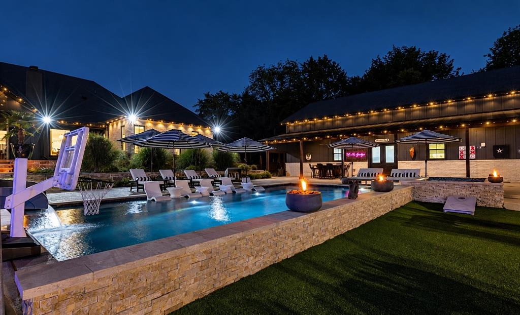 The pool, covered entertaining areas, and outdoor kitchen create a wonderful setting for gatherings with family and friends.