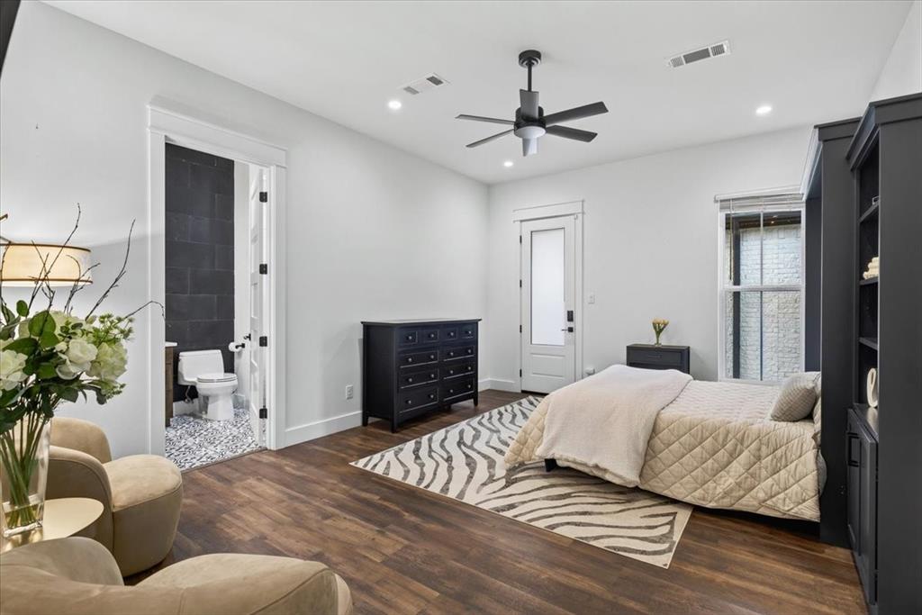 Bedroom Two features an ensuite bath and built-in Murphy bed, offering flexibility as a guest bedroom or home office, with direct exterior access to the detached garage and gym. Main Residence.